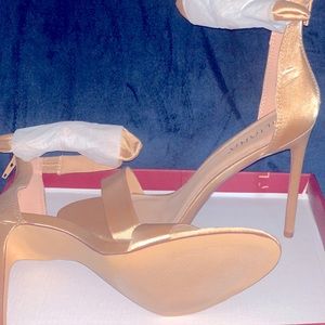 Gold satin high heel sandals.